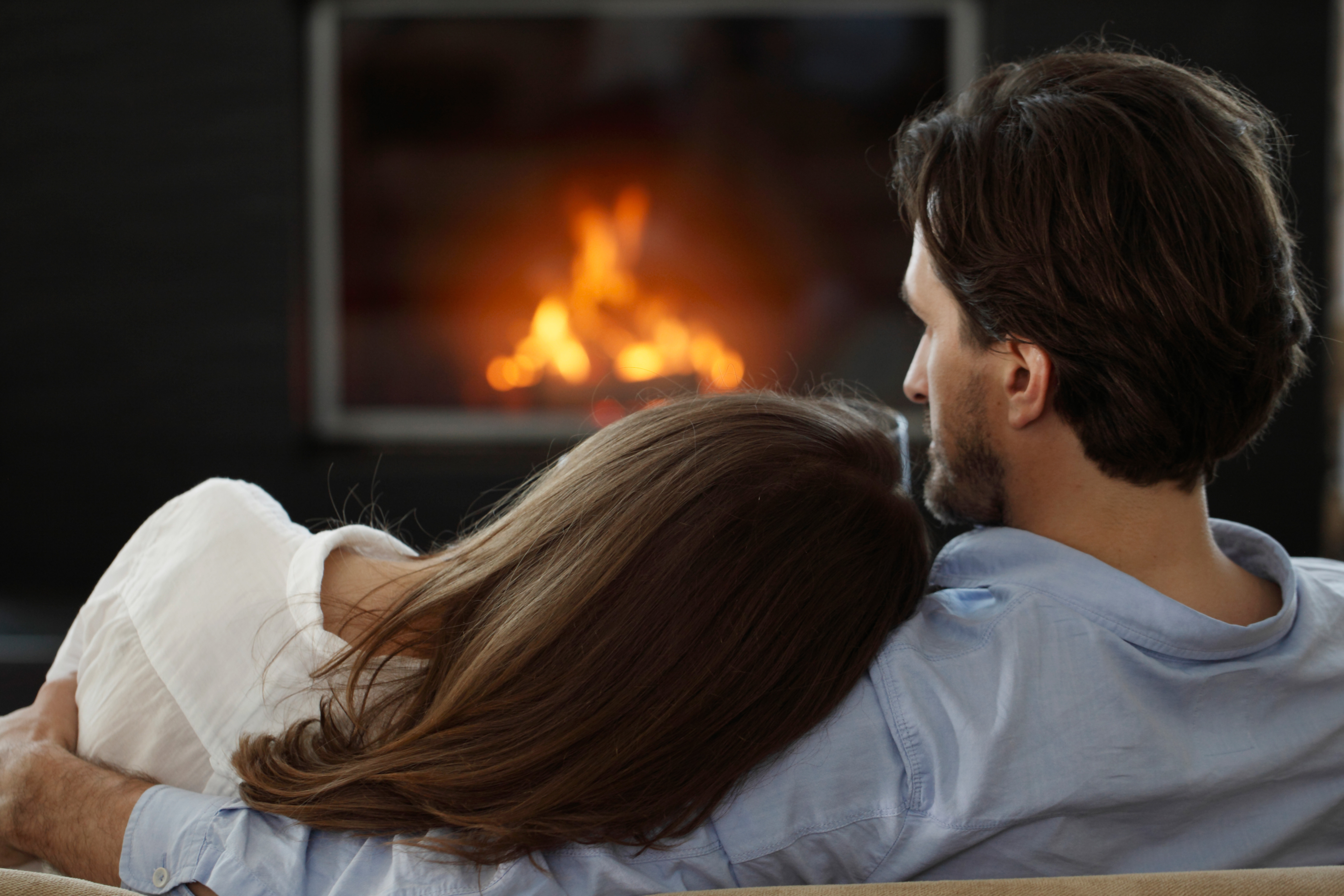 couple next to the fireplace.